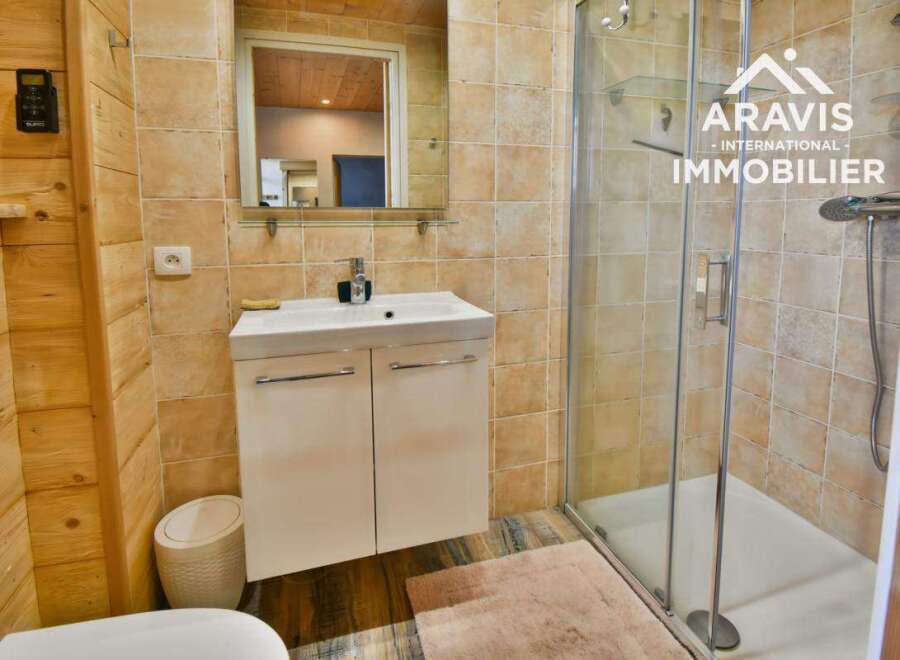 Discover this charming bathroom featuring a modern vanity and a sleek glass shower enclosure.