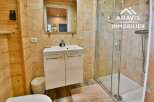 Discover this charming bathroom featuring a modern vanity and a sleek glass shower enclosure.