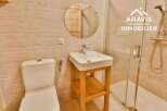 Discover this charming bathroom featuring a modern sink and a convenient toilet.