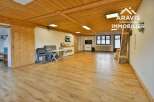 Discover the charm of this spacious property, featuring a warm wooden ceiling and inviting hardwood floors.