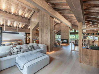 Experience luxury living in this stunning chalet-style home, featuring exquisite wooden beams and paneling throughout.