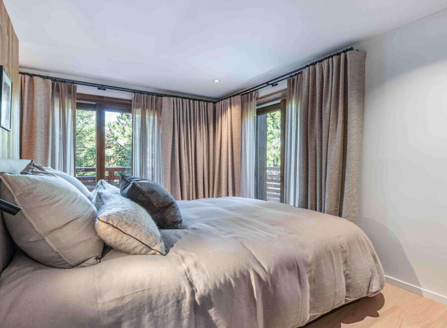 Experience the tranquility of this stunning bedroom, featuring a serene ambiance and natural light.