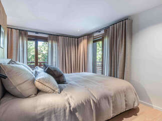 Experience the tranquility of this stunning bedroom, featuring a serene ambiance and natural light.