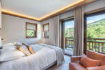 Experience the tranquility of this stunning bedroom, featuring a seamless blend of modern design and natural elements.