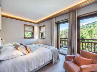 Experience the tranquility of this stunning bedroom, featuring a seamless blend of modern design and natural elements.