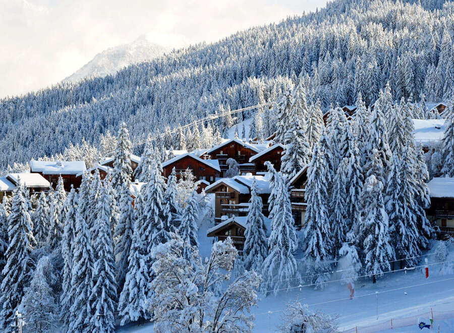 Nestled amidst a snow-covered mountain, this charming property offers a serene winter escape.