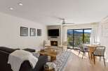 Experience luxury living in this stunning property featuring a cozy fireplace and a modern entertainment setup.