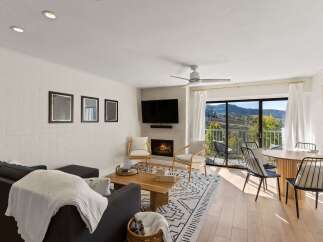 Experience luxury living in this stunning property featuring a cozy fireplace and a modern entertainment setup.