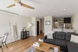 This stunning living space boasts a modern design with a cozy sectional sofa, perfect for relaxing.