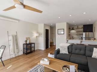 This stunning living space boasts a modern design with a cozy sectional sofa, perfect for relaxing.