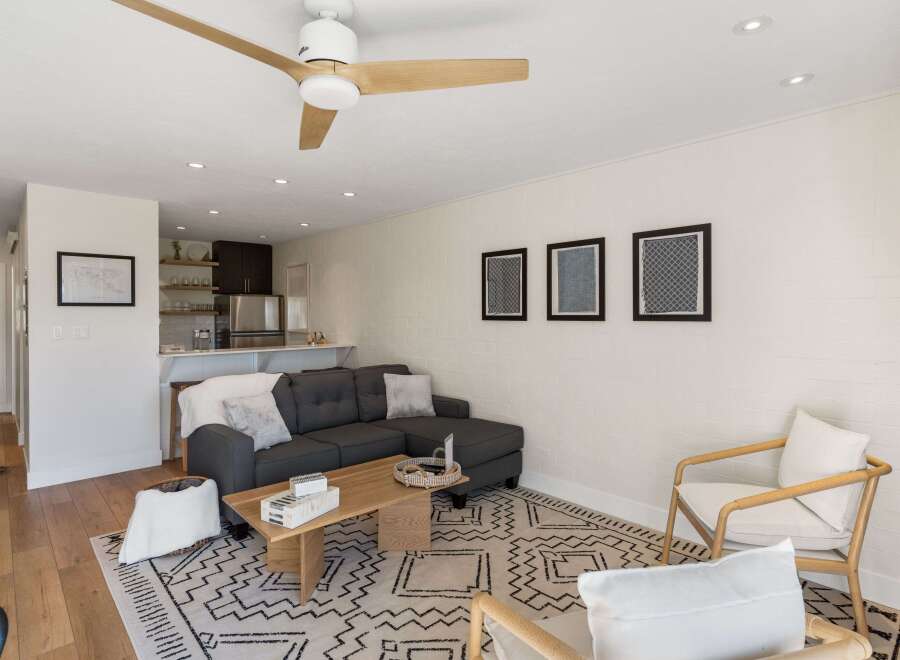 Step into this inviting living space, featuring a modern sectional sofa and a stylish coffee table, perfect for relaxation and entertaining.