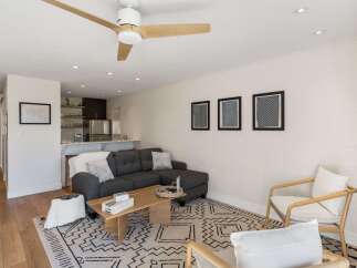 Step into this inviting living space, featuring a modern sectional sofa and a stylish coffee table, perfect for relaxation and entertaining.