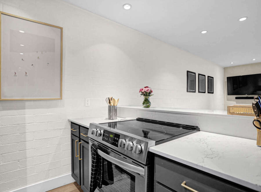 This modern kitchen boasts sleek countertops and stainless steel appliances, perfect for culinary enthusiasts.