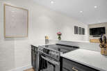 This modern kitchen boasts sleek countertops and stainless steel appliances, perfect for culinary enthusiasts.