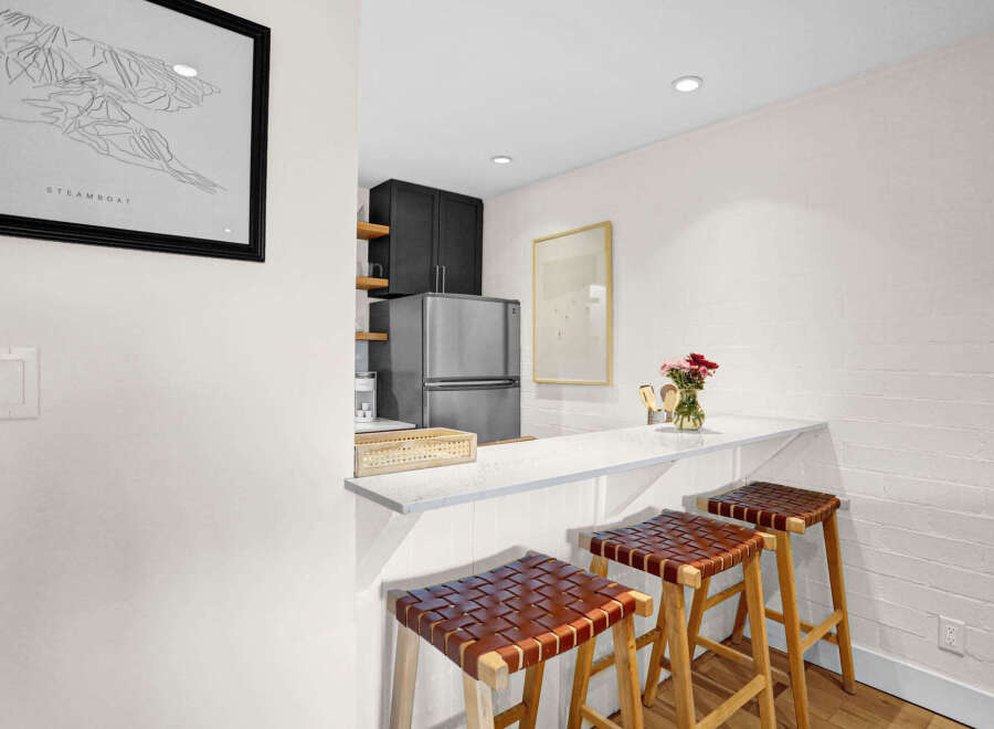 This stunning kitchen features a sleek breakfast bar, perfect for casual dining or entertaining.