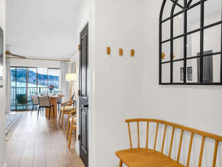 Step into this inviting entryway, showcasing a stylish arched mirror and a charming wooden bench.