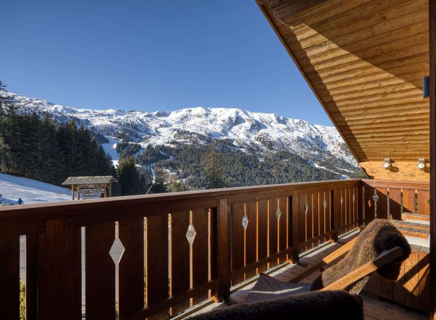 Enjoy breathtaking mountain views from this charming chalet balcony.