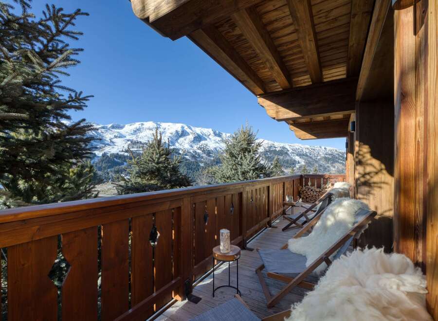 Enjoy breathtaking mountain views from this stunning chalet balcony.
