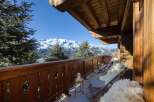 Enjoy breathtaking mountain views from this stunning chalet balcony.