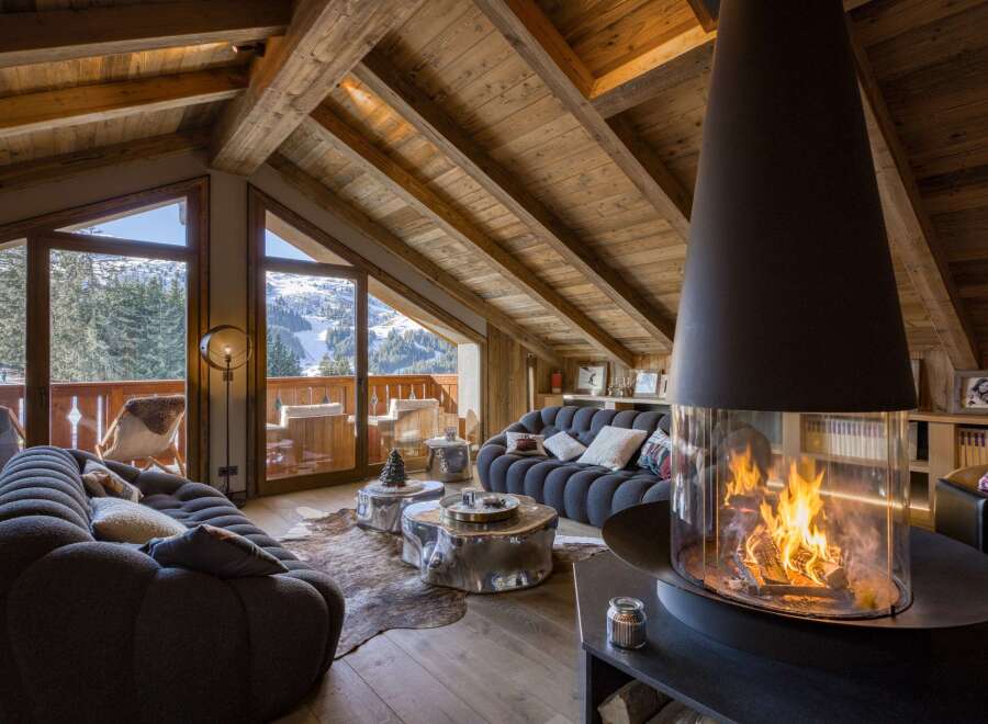 Experience the epitome of luxury living in this stunning chalet, boasting a cozy ambiance with a modern fireplace.