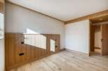 This stunning room features a beautiful wooden floor and walls, creating a warm and inviting atmosphere.