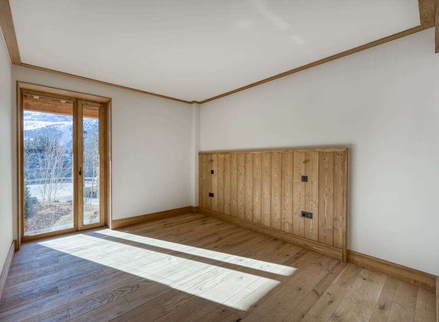 This stunning room boasts a warm and inviting atmosphere with its natural wood accents and ample sunlight.