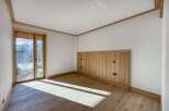 This stunning room boasts a warm and inviting atmosphere with its natural wood accents and ample sunlight.