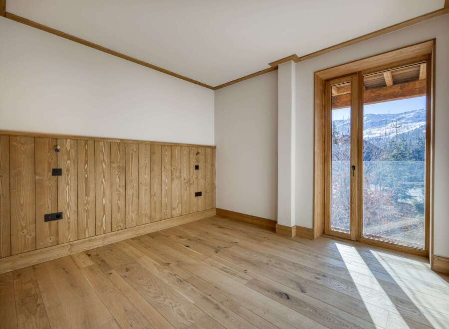 This stunning room boasts a warm and inviting atmosphere with its natural wood accents and flooring.