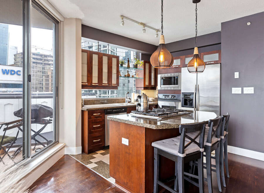 This stunning kitchen boasts modern appliances, including a gas cooktop and stainless steel refrigerator.