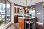 This stunning kitchen boasts modern appliances, including a gas cooktop and stainless steel refrigerator.