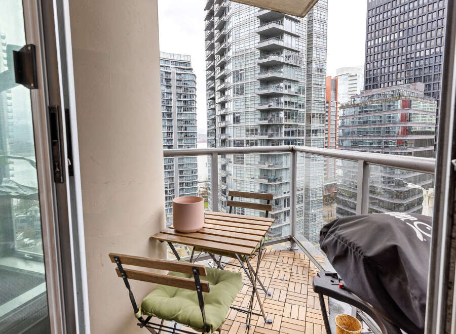 Enjoy stunning city views from this modern condo balcony.