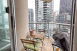 Enjoy stunning city views from this modern condo balcony.