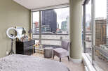 This stunning urban apartment boasts breathtaking city views from expansive windows.