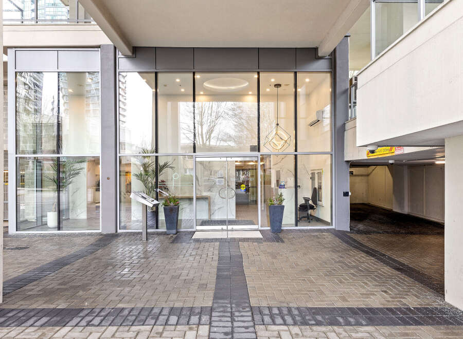 Discover luxury living at 1228 West Hastings! This stunning property boasts a modern facade with expansive glass windows, offering a glimpse into the sophisticated interiors.