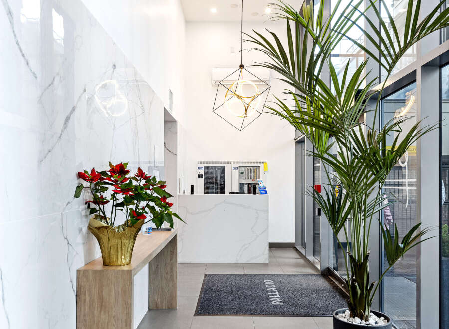 Step into the elegant lobby of this stunning property, showcasing a modern design with marble accents and a welcoming atmosphere.