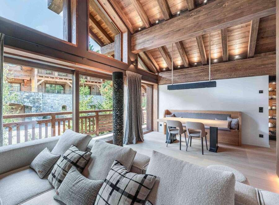 This stunning property boasts a luxurious interior with exposed wooden beams and expansive windows that flood the space with natural light.