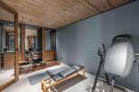 Step into your dream home gym! This space features a stunning wooden ceiling, creating a warm and inviting atmosphere.
