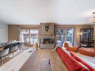 Experience the epitome of luxury living in this stunning property, featuring a cozy fireplace and expansive windows that frame breathtaking snowy views.