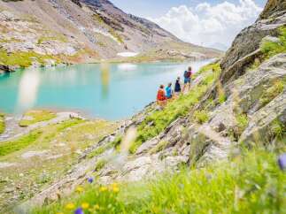Explore the breathtaking beauty of this stunning mountain property, offering unparalleled views of a pristine turquoise lake.