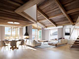 Experience luxury living in this stunning chalet, featuring a warm and inviting interior with exposed wooden beams and a cozy fireplace.