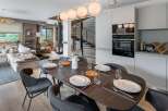Experience luxury living in this stunning property, featuring a modern dining area perfect for entertaining.