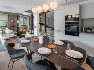 Experience luxury living in this stunning property, featuring a modern dining area perfect for entertaining.