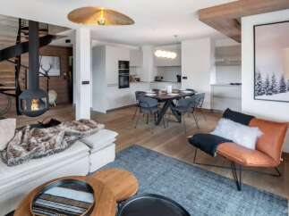 Experience luxury living in this stunning property, featuring a modern design with a cozy fireplace and a unique spiral staircase.