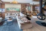 Experience luxury living in this stunning property featuring a cozy living room with a fireplace and a comfortable sofa.