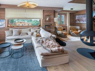Experience luxury living in this stunning property featuring a cozy living room with a fireplace and a comfortable sofa.