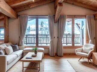 Experience the charm of this stunning property, featuring a cozy living room with exposed wooden beams and large windows offering breathtaking views.