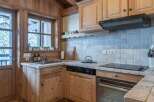 This charming kitchen features a rustic design with wooden cabinetry and countertops, creating a warm and inviting atmosphere.