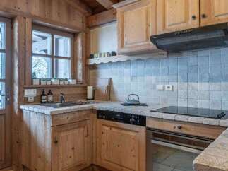 This charming kitchen features a rustic design with wooden cabinetry and countertops, creating a warm and inviting atmosphere.