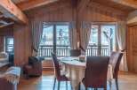 Experience the charm of this stunning property, featuring a cozy dining area with a round table and comfortable chairs.