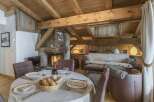 Experience the charm of this rustic retreat, featuring a cozy fireplace and exposed wooden beams.
